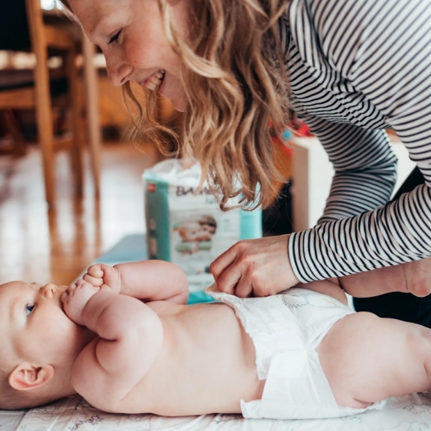 Baby being tickled by Mum in Bambo Nappies from Abena