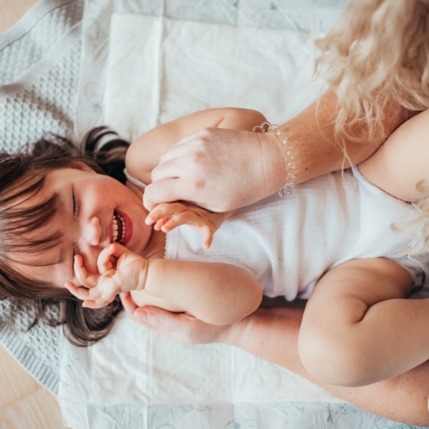 Toddler in Bambo Nappies laughing with mum