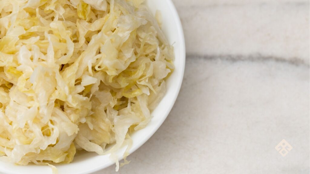 A serving of homemade sauerkraut on a plate, showcasing its vibrant colour and probiotic-rich benefits for gut health.