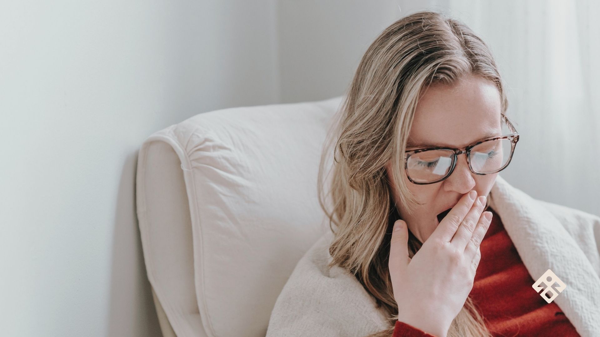 A tired woman yawning, struggling with low energy and exhaustion – how to fix low energy naturally.