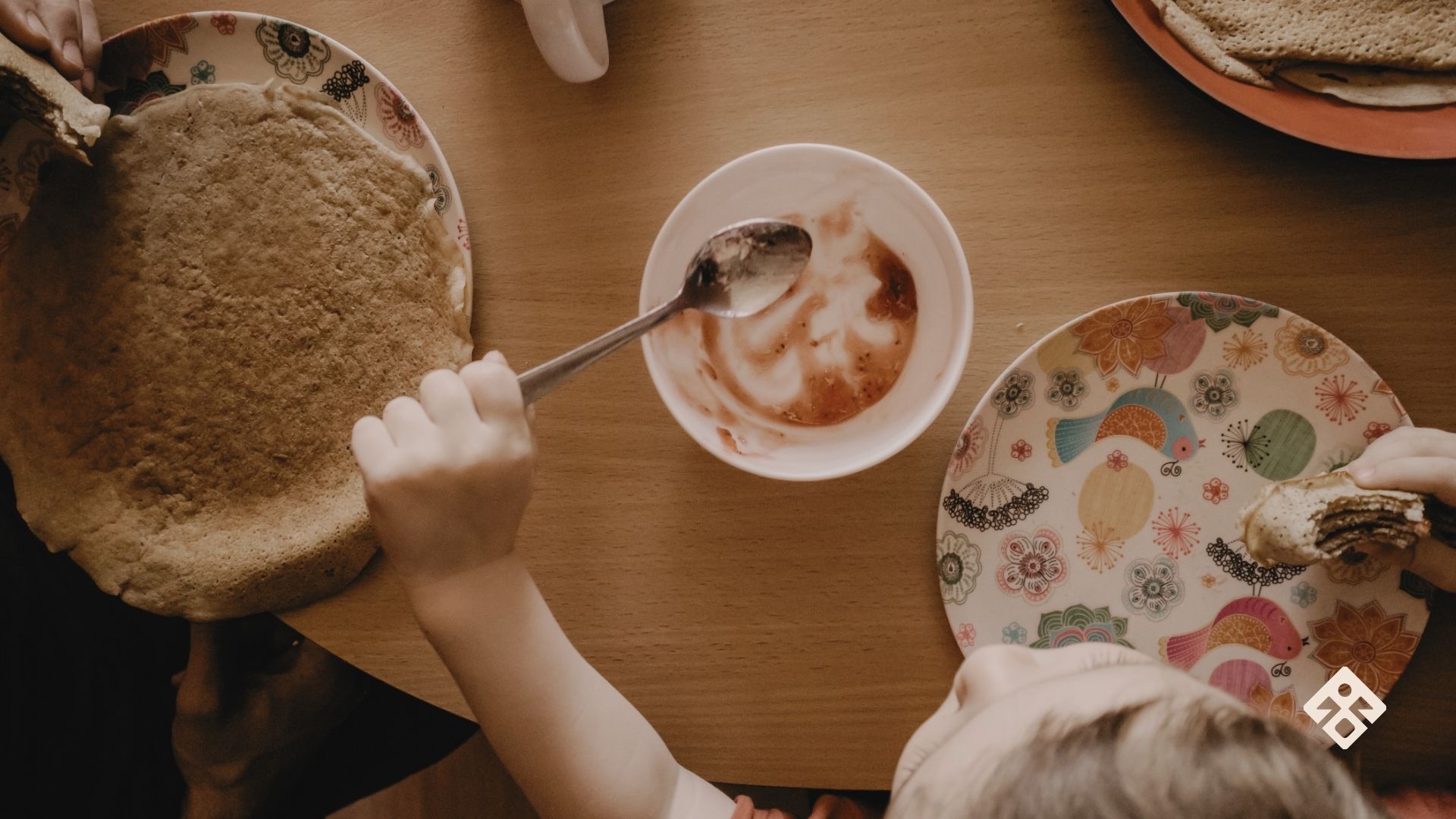 A young child eating a pancake, highlighting the link between nutrient deficiencies and child development.