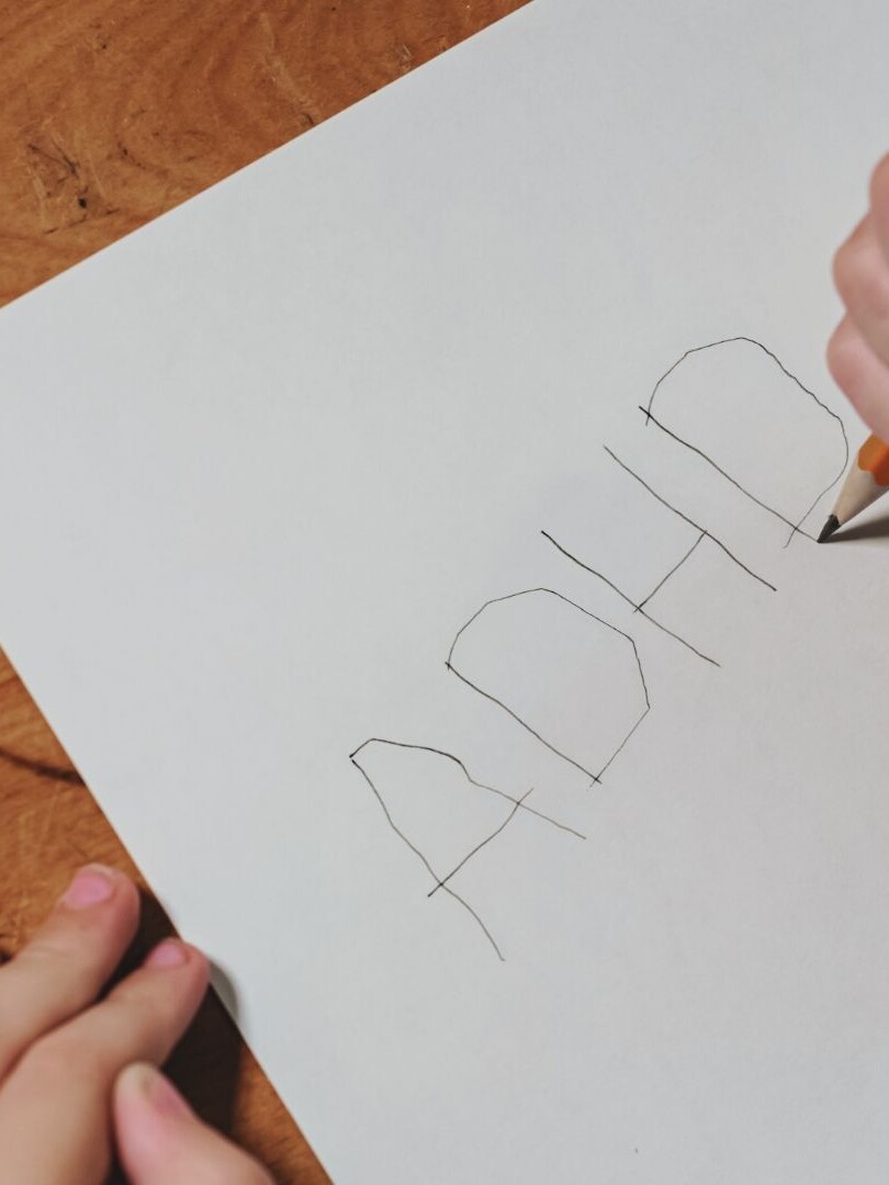 ADHD Symptoms in Children written by a child on a piece of paper — highlighting early signs and deeper causes often missed in mainstream narratives.