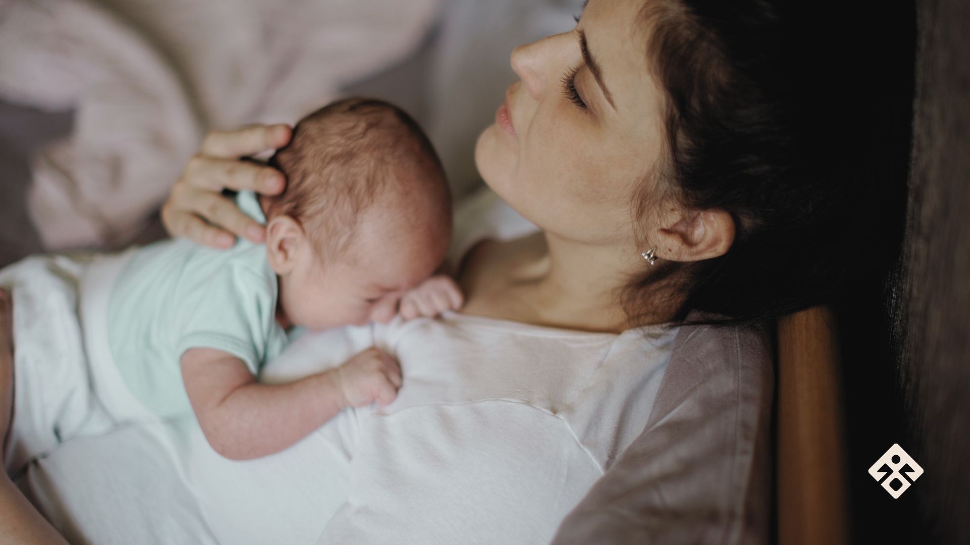 A tired mother sitting alone with her baby, looking emotionally flat and burnt out—capturing the quiet weight of maternal burnout.