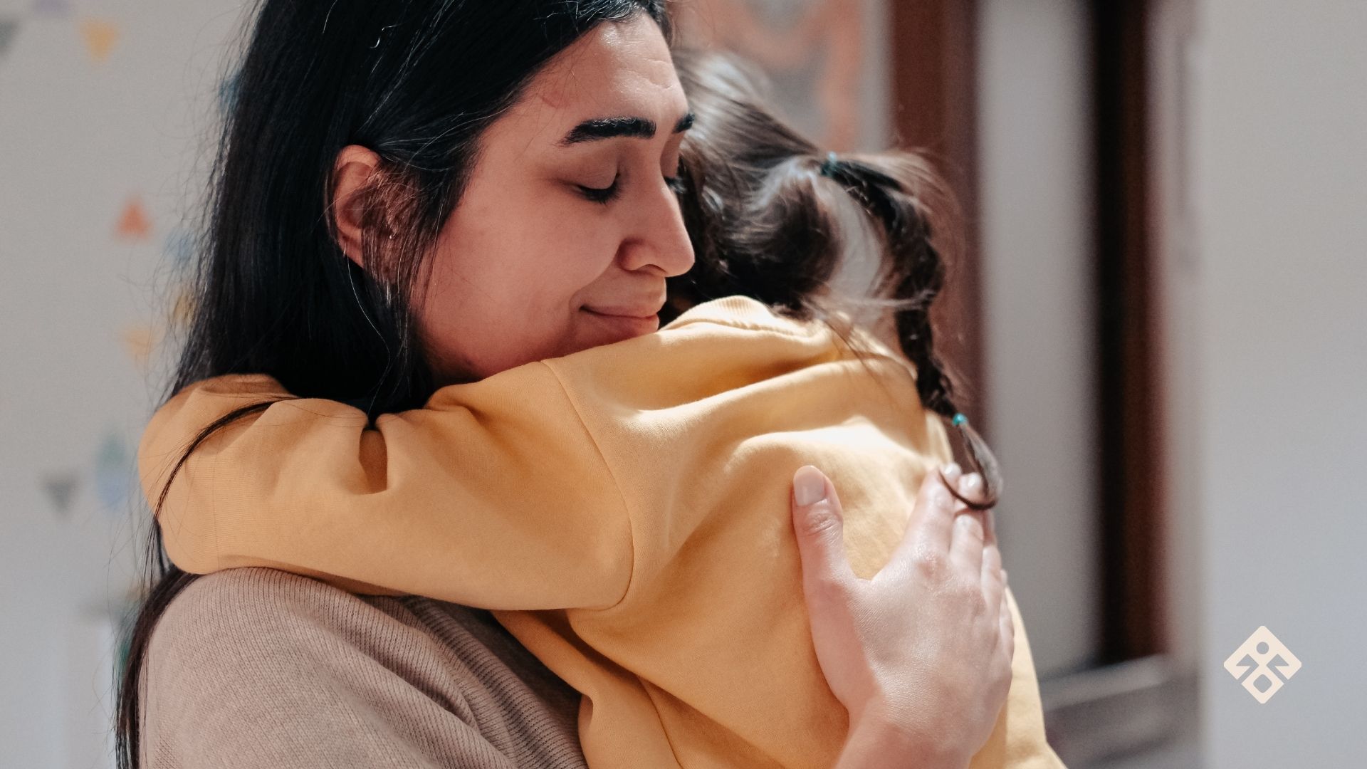 Mother holding child in a quiet moment, showing signs of emotional overwhelm and silent struggle with postpartum rage.